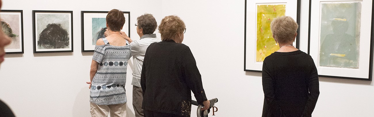 Visitors view an exhibition at the Judith & Norman Alix Art Gallery
